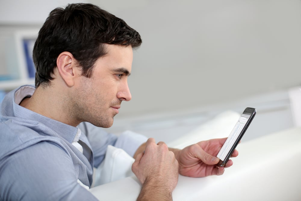 Profile view of man connected on smartphone